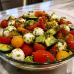 Tomato Cucumber Salad with Avocado Mozzarella and Basil Pesto